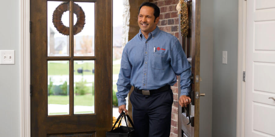 Technician walking through the door